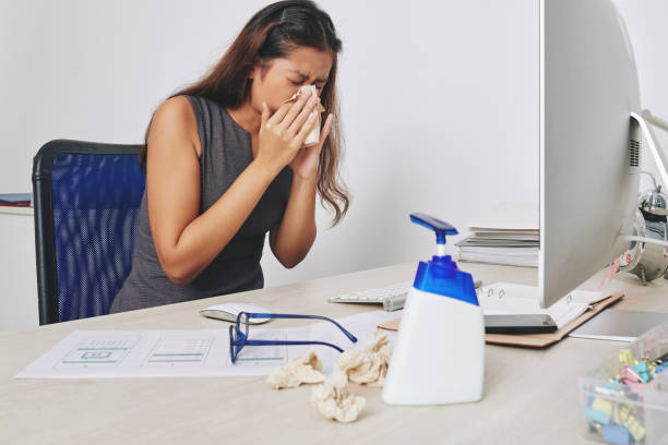 istock Sneezing businesswoman 1254550898