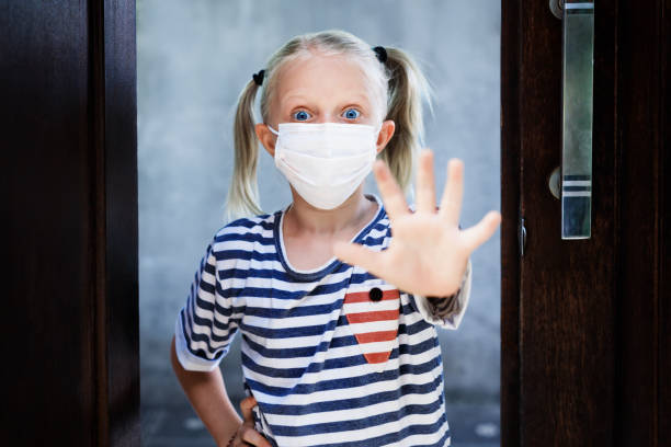 istock Child wearing face mask show hand gesture Stop 1254551204