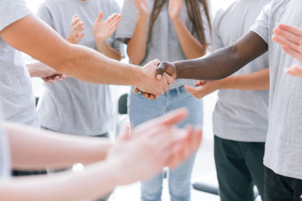 istock close up. youth forum participants applauding their leaders 1254551562