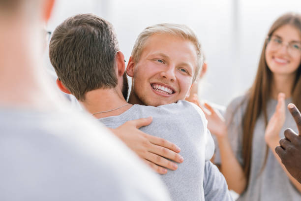 istock close up. happy contestants hugging each other 1254551599