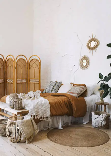 Photo of Comfort bedroom in boho style interior with lovely furnishing
