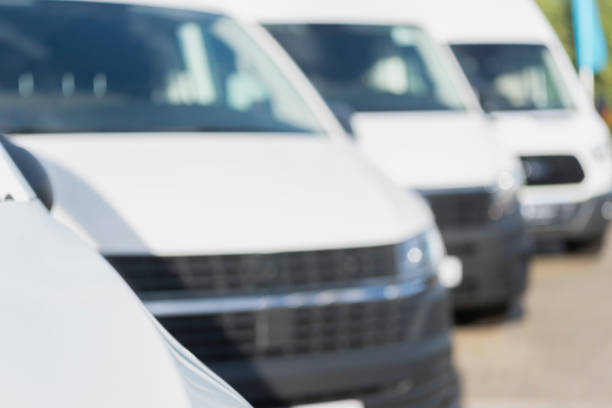istock Blurred view of a row of white vans 1254551699