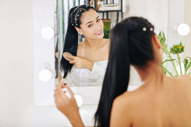 istock Young woman brushing hair 1254553098