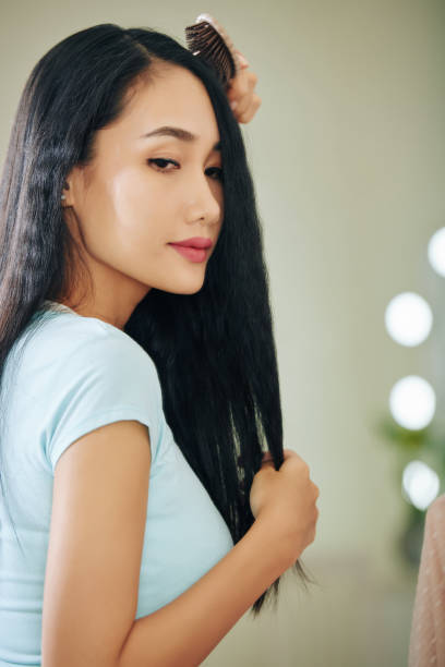 istock Young woman brushing hair 1254553112
