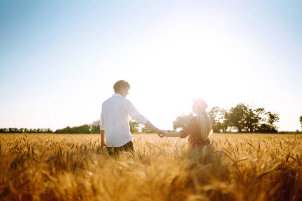 istock Couple having fun and enjoying relaxation in a wheat field. 1254556382