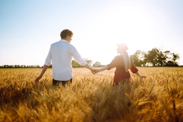 istock Couple having fun and enjoying relaxation in a wheat field. 1254556401