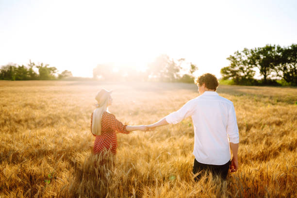 istock Couple having fun and enjoying relaxation in a wheat field. 1254556440