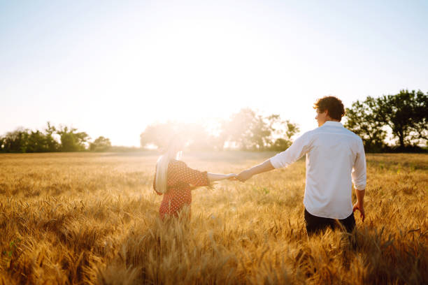istock Couple having fun and enjoying relaxation in a wheat field. 1254556447