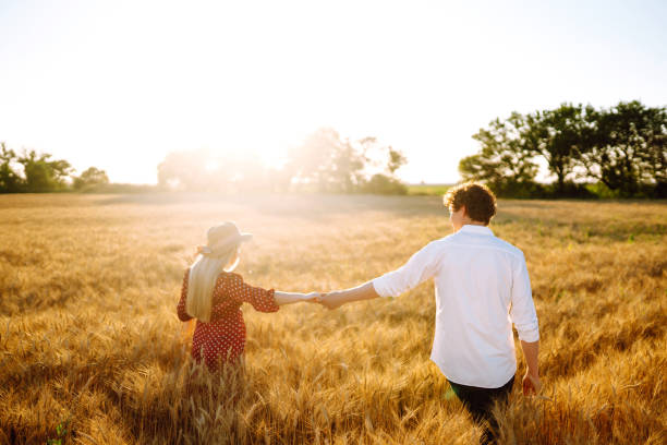 istock Couple having fun and enjoying relaxation in a wheat field. 1254556458
