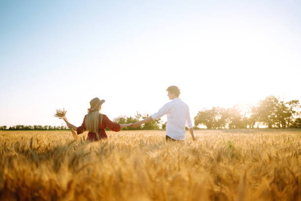 istock Couple having fun and enjoying relaxation in a wheat field. 1254556464