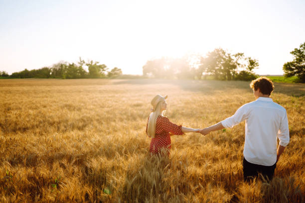 istock Couple having fun and enjoying relaxation in a wheat field. 1254556465