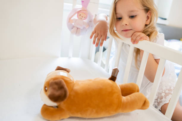 istock Blonde little girl with her teddy bear 1254556593