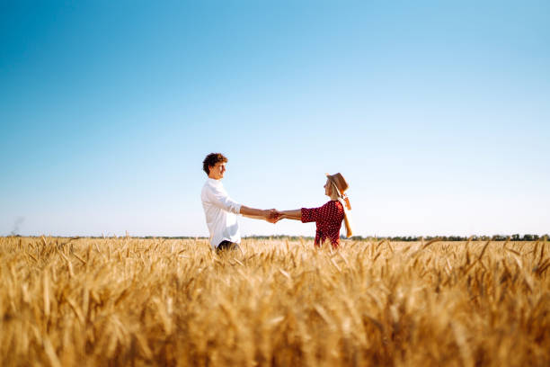 istock Couple having fun and enjoying relaxation in a wheat field. 1254556706