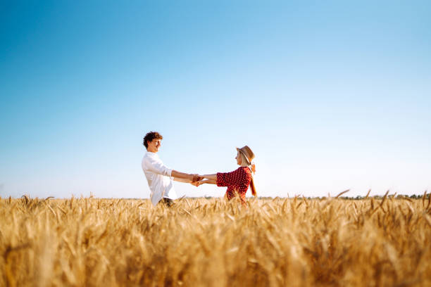 istock Couple having fun and enjoying relaxation in a wheat field. 1254556777
