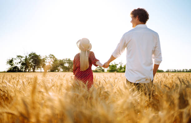 istock Couple having fun and enjoying relaxation in a wheat field. 1254556839