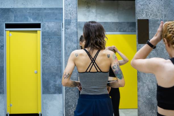 istock Women getting ready in the gym locker room 1254557595