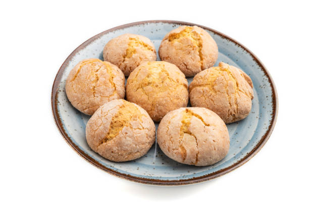 istock Almond cookies on blue plate isolated on white background. Side view, close up. 1254561631