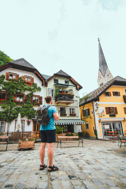 istock traveler with backpack at central city square in hallstatt 1254561748