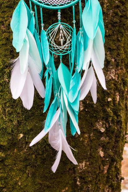 istock Handmade dream catcher with feathers threads and beads rope hanging 1254562413