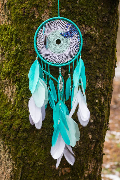 istock Handmade dream catcher with feathers threads and beads rope hanging 1254562418