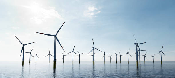 Offshore wind turbines farm on the ocean. Sustainable energy Offshore wind turbines farm on the ocean. Sustainable energy production, clean power. windmill stock pictures, royalty-free photos & images