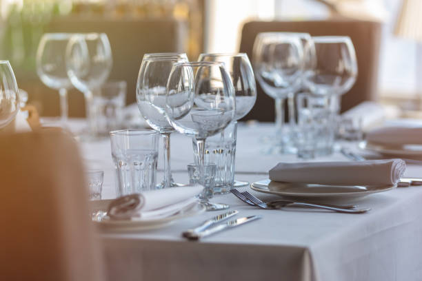 istock Empty glasses in restaurant background. Table set for an event party or wedding reception. 1254562775