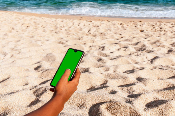 istock With the mobile phone on the beach 1254562842