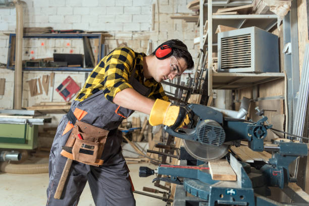 istock Carpenter using a circular saw to cut a large board of wood a new home constructiion project 1254563183
