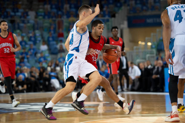 istock Basketball players chasing for ball 1254563975