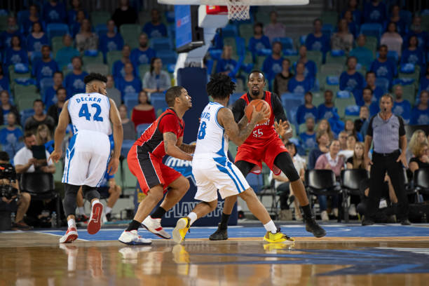 istock Basketball players chasing for ball 1254563986