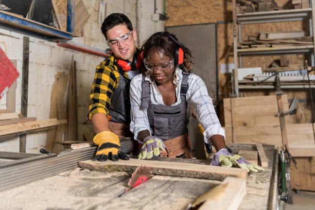 istock Afro Woman as carpenter working with circular saw at workshop 1254564007