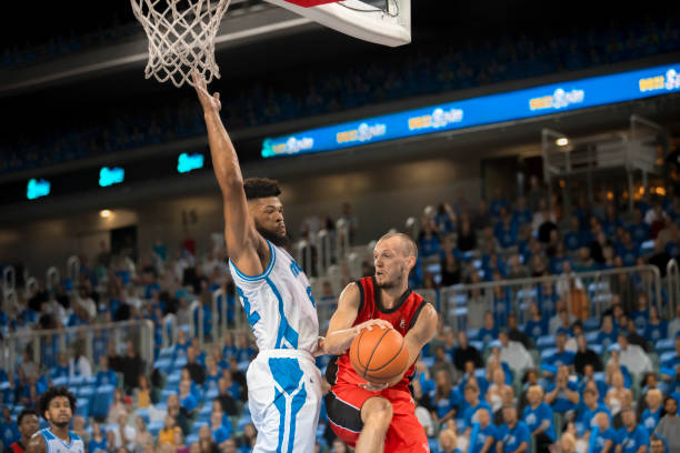 istock Basketball players chasing for ball 1254564066