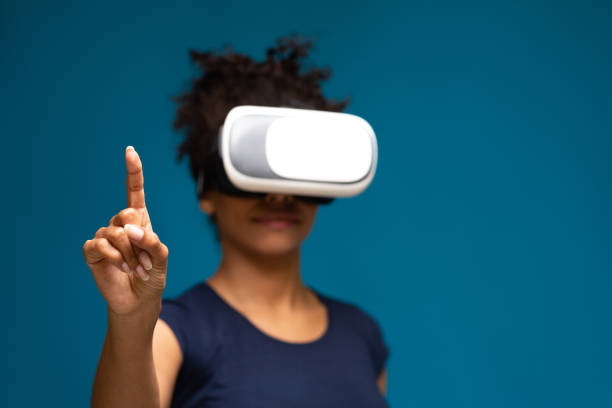 istock African american lady using VR headset, touching invisible touchscreen 1254564484
