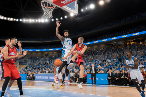 istock Basketball players chasing for ball 1254564507