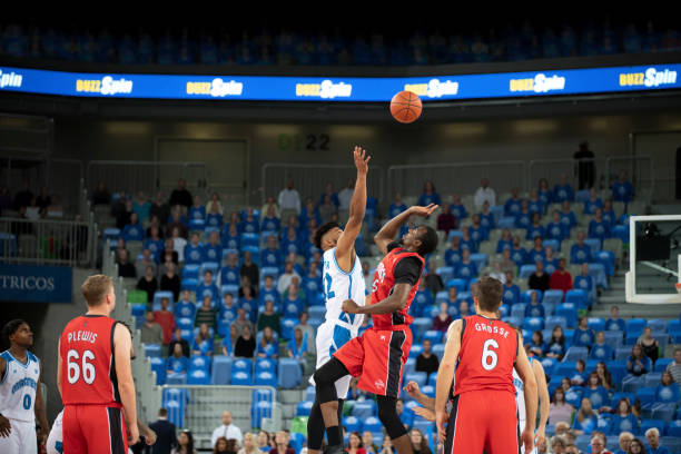 istock Basketball players chasing for ball 1254565414