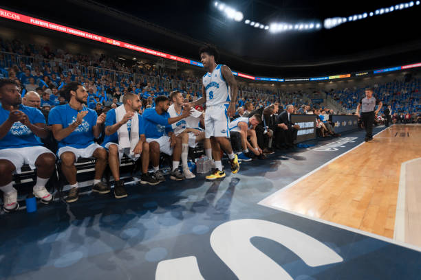 istock Basketball player shaking hand with his teammates 1254565497