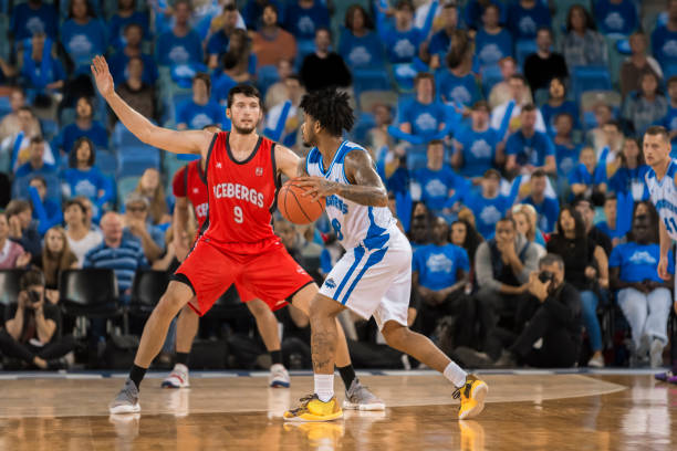 istock Basketball players chasing for ball 1254565576