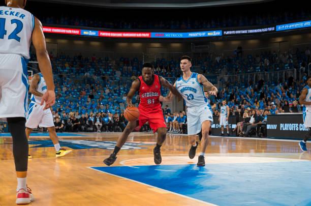 istock Basketball players chasing for ball 1254565794