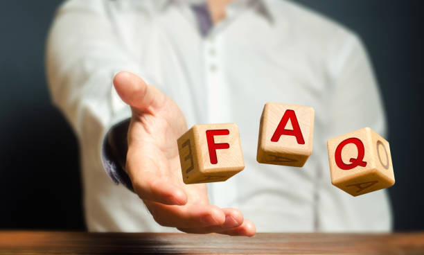 istock Cubes thrown by a man make word abbreviation acronym FAQ (frequently asked questions). Convenient form of answers explanations for users and customers. Instructions and rules. Avoid frequent errors. 1254565979
