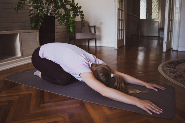 istock Woman exercising at home 1254568436