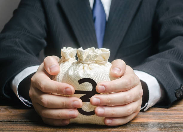 Businessman hugs ukraine hryvnia money bags. Budget, tax collection. Granting financing business project. Trade, economics. Growth of corruption kickbacks, appropriation of funds. Provision loan. el hombre de negocios abraza bolsas de dinero de ucrania hryvnia. presupuesto, recaudación de impuestos. concesión de financiación de proyectos empresariales. comercio, economía. crecimiento de los contratiempos de corrupción, apropiación de fondos.