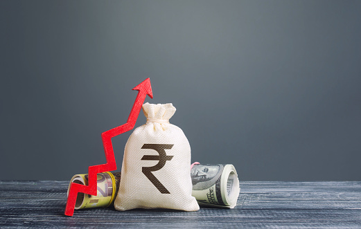 Indian rupee money bag and red arrow up. Influx of investment and capital, increase of wealth. Rising inflation. Economic recovery and growth, optimistic forecast of economic rise. Market stability.