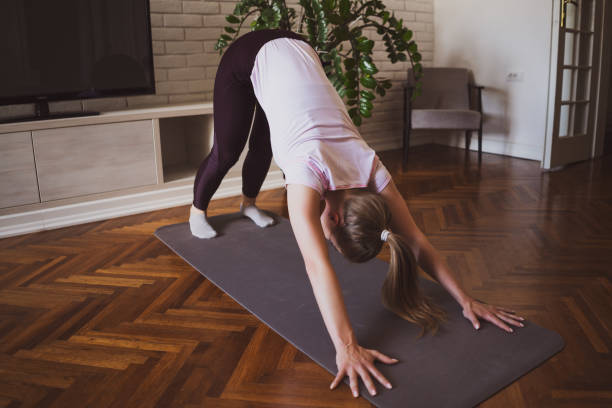 istock Woman exercising at home 1254568570