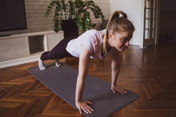istock Woman exercising at home 1254569245