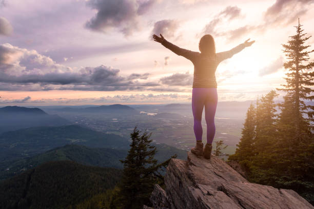 istock Girl on the mountain during sunset 1254569392
