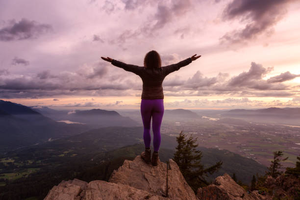 istock Girl on the mountain during sunset 1254569434