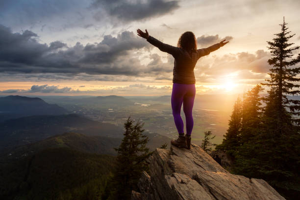 istock Girl on the mountain during sunset 1254569481