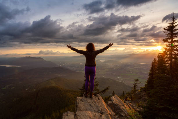 istock Girl on the mountain during sunset 1254569557