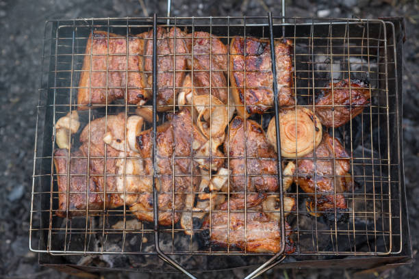 Juicy pork ribs with fried onions fried on a grill