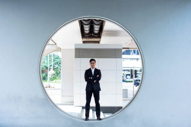 istock Mature Hong Kong Businessman Standing Within Oculus Window 1254569889